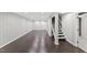 Spacious finished basement with wood-look flooring, bright lighting, and stairway at 5541 Old Still Rd, Wake Forest, NC 27587