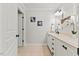Bathroom featuring double sinks, white cabinets, and jellyfish-themed wall art at 5541 Old Still Rd, Wake Forest, NC 27587