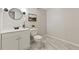 Updated bathroom with decorative mirror, modern vanity, and stylish floor tiles at 5541 Old Still Rd, Wake Forest, NC 27587
