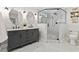 Bathroom with a double sink vanity, decorative mirrors, and tiled shower at 5541 Old Still Rd, Wake Forest, NC 27587