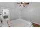 Bright bedroom featuring hardwood floors and an en-suite bath with gray vanity at 5541 Old Still Rd, Wake Forest, NC 27587