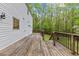 Spacious wooden deck with railings offers views of the yard and mature trees at 5541 Old Still Rd, Wake Forest, NC 27587