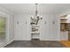 Dining area with ample built-in cabinet storage, stylish chandelier, and outdoor view at 5541 Old Still Rd, Wake Forest, NC 27587