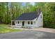 View of house showcasing the covered porch, driveway and well maintained lawn at 5541 Old Still Rd, Wake Forest, NC 27587