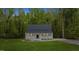 Charming home featuring a covered front porch, manicured lawn, and mature trees at 5541 Old Still Rd, Wake Forest, NC 27587