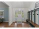 Bright foyer featuring hardwood floors and a built-in storage bench with coat hooks at 5541 Old Still Rd, Wake Forest, NC 27587