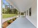 Long covered front porch featuring white columns and a painted blue floor at 5541 Old Still Rd, Wake Forest, NC 27587