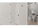 Hallway leading to a bathroom with a toilet and decorative fern at 5541 Old Still Rd, Wake Forest, NC 27587