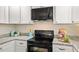 Kitchen featuring white cabinets, granite countertops, and modern appliances at 5541 Old Still Rd, Wake Forest, NC 27587