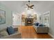Bright living room featuring a stone fireplace, hardwood floors, and comfortable seating at 5541 Old Still Rd, Wake Forest, NC 27587