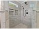 Walk-in shower featuring custom tile work, storage, and multiple shower heads at 5541 Old Still Rd, Wake Forest, NC 27587