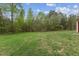 Expansive grassy backyard surrounded by trees, perfect for outdoor entertaining or recreation at 56 Marlless Dr # A & B, Franklinton, NC 27525