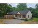 Exterior view of a charming tan duplex with red shutters and a gravel front yard at 56 Marlless Dr # A & B, Franklinton, NC 27525