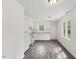 Kitchen with white cabinets, stainless steel appliances, and sleek wood grain floors at 56 Marlless Dr # A & B, Franklinton, NC 27525