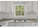 Bright kitchen view showcasing a double sink and natural light from the window at 56 Marlless Dr # A & B, Franklinton, NC 27525