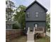 View of the exterior with a wooden deck, gray siding, and well-maintained landscaping at 612 E Ellerbee St, Durham, NC 27704