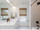 Bright bathroom featuring a double vanity, modern fixtures, and window views at 612 E Ellerbee St, Durham, NC 27704