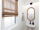 Well-lit powder room with a modern faucet, designer mirror, and natural light at 612 E Ellerbee St, Durham, NC 27704