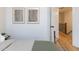Bedroom with neutral decor, hardwood floors, and a view of the staircase through an open door at 612 E Ellerbee St, Durham, NC 27704