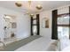 Bedroom featuring a modern gold light fixture, dark curtains, and an ensuite bathroom view at 612 E Ellerbee St, Durham, NC 27704