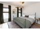 Serene bedroom with natural light, dark green curtains, and a stylish light fixture at 612 E Ellerbee St, Durham, NC 27704