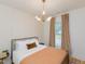 Cozy bedroom boasts natural light from the window and stylish, modern light fixture at 612 E Ellerbee St, Durham, NC 27704