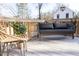 Cozy outdoor living space with a modern chair and comfortable bench seating, surrounded by plants at 612 E Ellerbee St, Durham, NC 27704