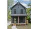 Charming two-story home with a welcoming front porch, natural wood columns, and tasteful landscaping at 612 E Ellerbee St, Durham, NC 27704