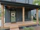 Charming front porch with stylish seating, a decorative wreath, and wooden columns, offering a warm welcome at 612 E Ellerbee St, Durham, NC 27704