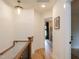 Upstairs hallway with wood floors, modern lighting, and access to a bedroom at 612 E Ellerbee St, Durham, NC 27704