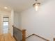 Upstairs hallway with wood floors, modern lighting, and access to bedrooms and bathrooms at 612 E Ellerbee St, Durham, NC 27704