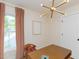 Office with mid-century desk, pink curtains, modern light fixture, and framed artwork at 612 E Ellerbee St, Durham, NC 27704