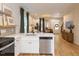 Open floorplan kitchen with stainless appliances, white cabinets, and breakfast bar overlooking the living area at 612 E Ellerbee St, Durham, NC 27704