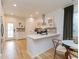 Modern kitchen with white cabinets, stainless steel appliances, a breakfast bar, and hardwood floors at 612 E Ellerbee St, Durham, NC 27704