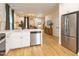 Modern open floorplan kitchen with stainless steel appliances, white cabinets, and breakfast bar seating at 612 E Ellerbee St, Durham, NC 27704