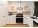 Well-lit kitchen featuring stainless steel appliances, white countertops, and a modern backsplash at 612 E Ellerbee St, Durham, NC 27704