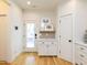 Bright kitchen area featuring white cabinets, stainless steel appliances, stylish decor, and hardwood flooring at 612 E Ellerbee St, Durham, NC 27704