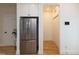 Bright kitchen features a stainless steel refrigerator and white cabinets for ample storage at 612 E Ellerbee St, Durham, NC 27704