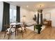 Open living space with modern chandelier, hardwood floors, dining table, and comfortable seating area at 612 E Ellerbee St, Durham, NC 27704