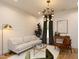 Well-lit living room featuring hardwood floors, a modern light fixture, and contemporary furniture at 612 E Ellerbee St, Durham, NC 27704