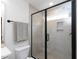 Modern shower with frameless glass door, neutral tiles, window, and recessed shelf at 612 E Ellerbee St, Durham, NC 27704