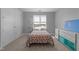 Cozy bedroom featuring a comfortable bed, neutral decor, and natural light from a large window at 618 N Boylan Ave # 304, Raleigh, NC 27603