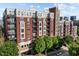 Beautiful brick building with multiple balconies and windows, surrounded by lush green trees and a clear blue sky at 618 N Boylan Ave # 304, Raleigh, NC 27603