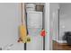 Efficient laundry closet featuring stacked washer and dryer with shelving for storage solutions at 618 N Boylan Ave # 304, Raleigh, NC 27603