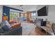 Stylish condo living room featuring wood floors, a cozy couch, and a modern ceiling fan at 618 N Boylan Ave # 304, Raleigh, NC 27603