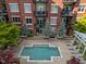 Modern condo building exterior with beautiful courtyard pool, landscaping, and private balconies at 618 N Boylan Ave # 304, Raleigh, NC 27603