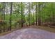 A brick patio offers ample space for outdoor entertaining amidst lush greenery at 635 Kensington Dr, Chapel Hill, NC 27514