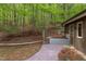 Stone path winds through the landscaped backyard, leading to a charming outbuilding at 635 Kensington Dr, Chapel Hill, NC 27514