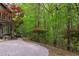 Beautiful backyard with a brick path leading to lush greenery and mature trees at 635 Kensington Dr, Chapel Hill, NC 27514