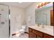 Cozy bathroom featuring tiled floors, a glass-enclosed shower, and a well-lit vanity area at 635 Kensington Dr, Chapel Hill, NC 27514